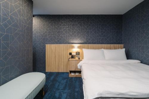 a hotel room with two beds and a bedskirts at Hotel attic in Taipei