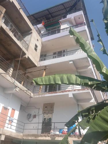 a building with balconies on the side of it at Satyam home stay in Dagshai