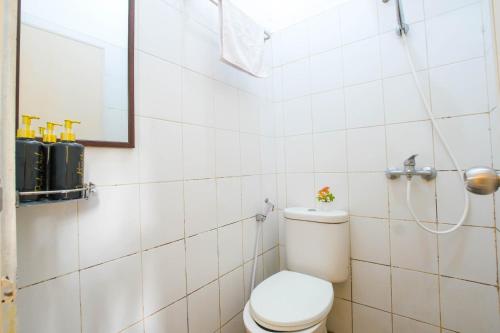 a bathroom with a toilet and a shower at Athena Syariah Residence in Tangerang