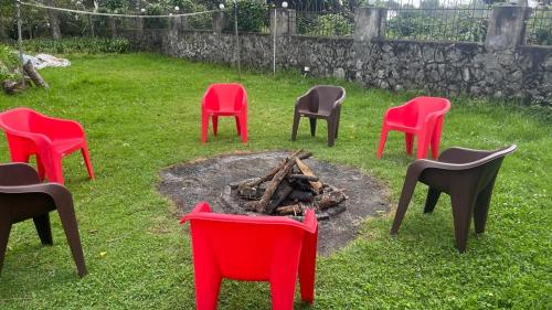 a group of chairs around a fire in a yard at Bruton resorts in Kodaikānāl