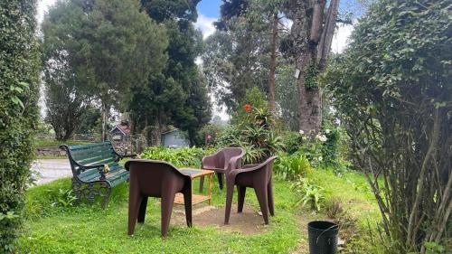 a group of chairs and a table and a bench at Bruton resorts in Kodaikānāl