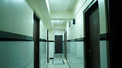 a hallway of a building with glass doors at Sai Sharan Stay Inn- Near MIDC Turbhe Navi Mumbai in Navi Mumbai