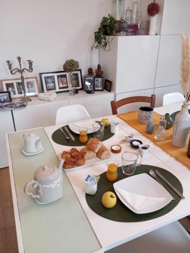 a table with breakfast food on it in a room at La Dolce Vita Lucie in Vals-les-Bains