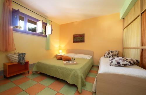 a small room with two beds and a window at Casa Paradiso in San Vito lo Capo
