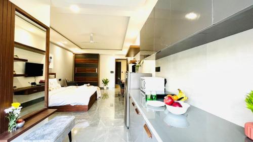 a hotel room with a bed and a kitchen at BluO Studio2 DLF Cybercity - Balcony, Gym TT, Lift in Gurgaon