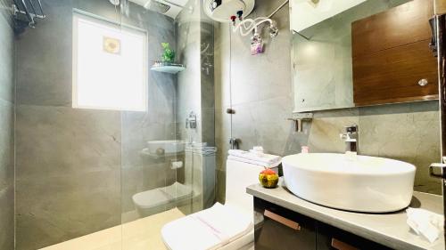 a bathroom with a sink and a shower and a toilet at BluO Studio2 DLF Cybercity - Balcony, Gym TT, Lift in Gurgaon
