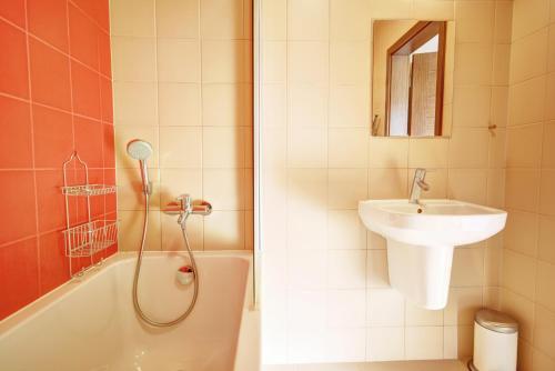 a bathroom with a shower and a sink and a tub at HelApart - Foka in Hel
