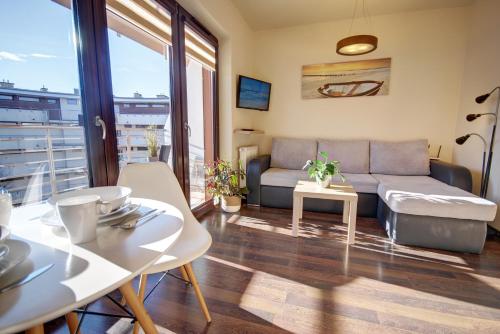 a living room with a couch and a table at HelApart - Foka in Hel