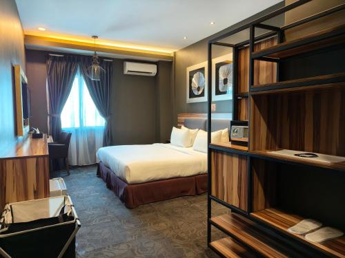 Ένα ή περισσότερα κρεβάτια σε δωμάτιο στο Asiatic Hotel
