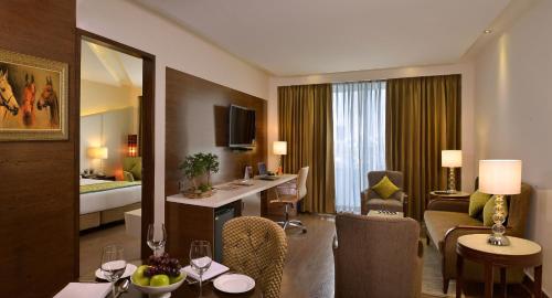 a hotel room with a living room and a suite at Golden Tulip Lucknow in Lucknow