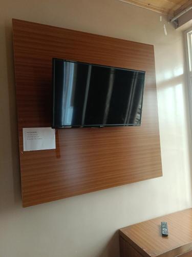 a flat screen tv hanging on a wall at VENUS Villa BOUTIQUE HOTEL KIGALI in Kigali