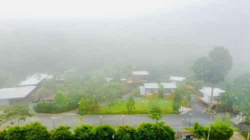 a foggy view of a parking lot in a park at Heaven Hill Camping in Ban Thung Na