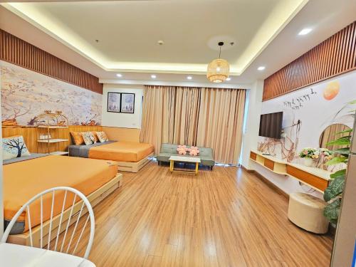 a hotel room with two beds and a couch at FLC Sea Tower Quy Nhơn, ban công view biển, bồn tắm, hồ bơi có phí , gần quản trường in Quy Nhon