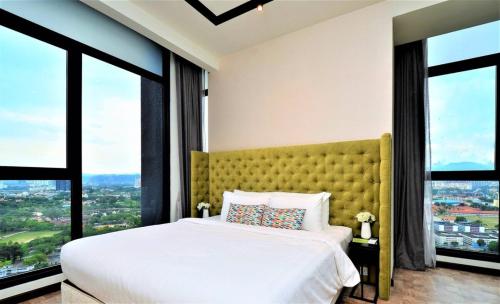 a bedroom with a large bed with large windows at Expressionz Professional Suites Kuala Lumpur in Kuala Lumpur