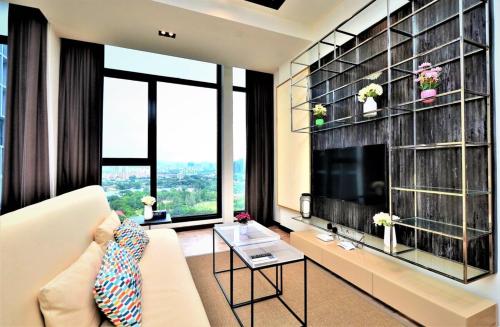 a living room with a white couch and a large window at Expressionz Professional Suites Kuala Lumpur in Kuala Lumpur