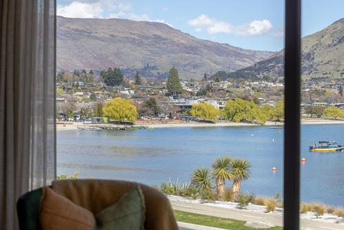 a view of a lake from a window at Marina Views - Luxury Apartment in Wanaka
