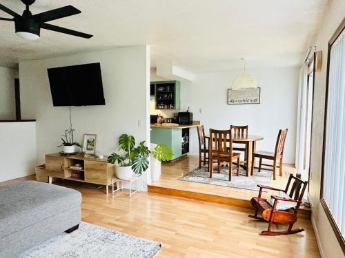 a living room with a table and a dining room at Hathaway a family home in Corvallis