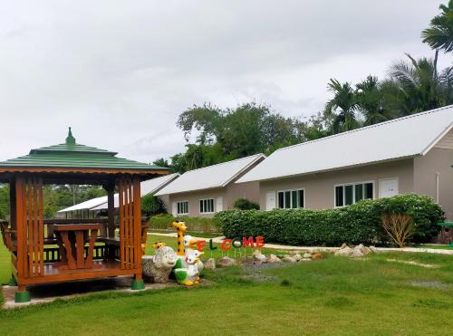 a house with a gazebo in a yard at Davy Cottage Phuket in Thalang