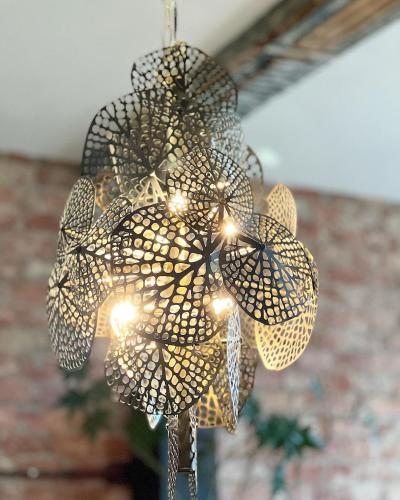 a chandelier with lights hanging from a ceiling at LouLou Home's in Antwerp