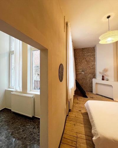 a bedroom with a bed and a window at LouLou Home's in Antwerp