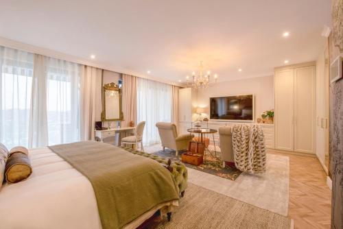 a hotel room with a bed and a dining room at The Weinberg Urban Pods in Windhoek