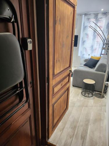 an open door to a living room with a couch at Ecouter le silence à LALOUVESC in Lalouvesc