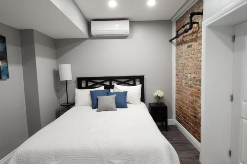 1 dormitorio con 1 cama blanca grande con almohadas azules en 12- Exec 1BD-Wifi-AC-Workspace en Windsor