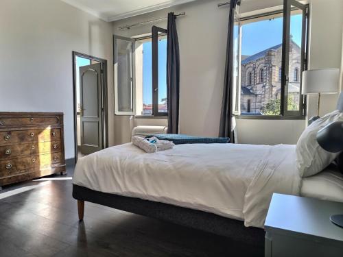 - une chambre avec un lit, une commode et des fenêtres dans l'établissement Le Coté Jardin - Fibre - Clim - Centre-ville, à Albi
