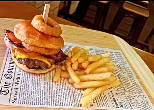 a hamburger and french fries on a table at Broken Hill Hotel in Boulder
