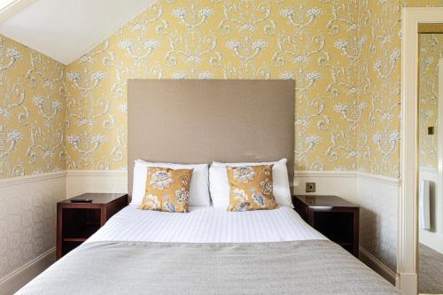 a bedroom with a large bed with two night stands at Bank House Pitlochry in Pitlochry