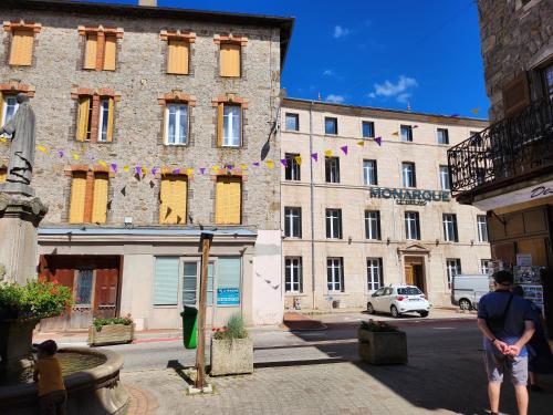 a man is standing in front of a building at Ecouter le silence à LALOUVESC in Lalouvesc