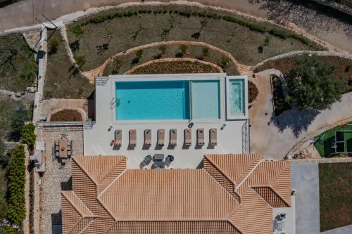 an aerial view of a house with a swimming pool at Archontiko Stoufi in Skinária