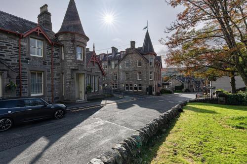 a car parked in front of a large building at Bank House Pitlochry in Pitlochry