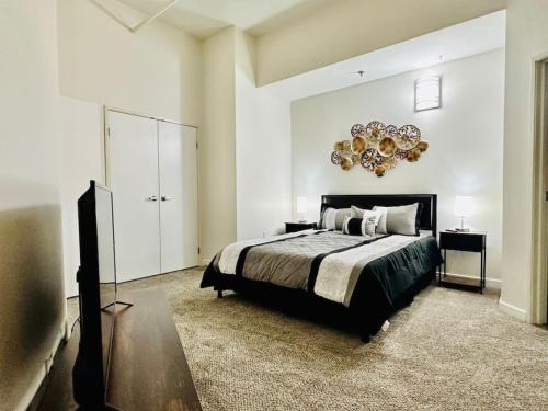 a bedroom with a bed and a television in it at 2 BR Contemporary Modern Loft in Indianapolis