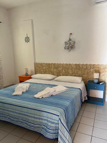 a bedroom with a bed with towels on it at Residence La Conchiglia in Lampedusa