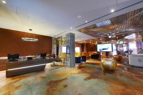 a hotel lobby with a reception desk and a television at CHECK inn HIVE in Luodong