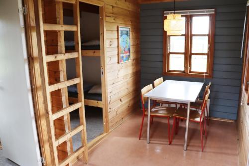 Pokój ze stołem, krzesłami i łóżkami piętrowymi w obiekcie Danhostel Haderslev w mieście Haderslev