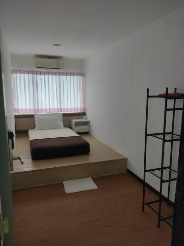 a bedroom with a bed and a book shelf at BKK TEAK Hostel in Amphoe Phra Khanong