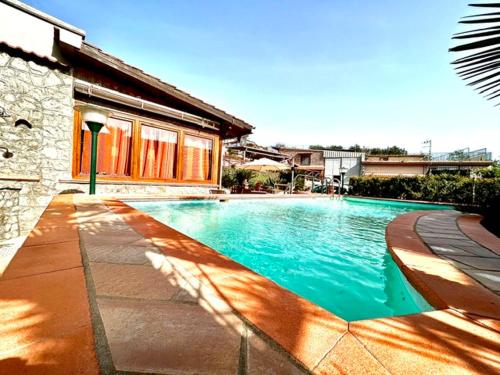 a swimming pool in front of a house at Casa Nicolò in Massa Lubrense