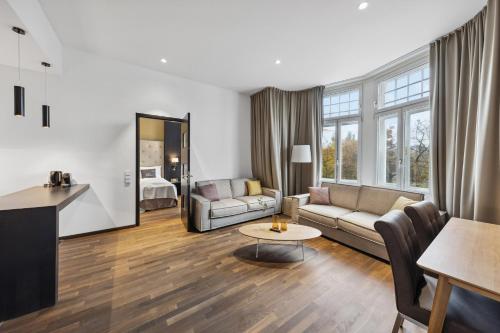 a living room with a couch and a table at Limehome Vienna Roßauer Lände in Vienna