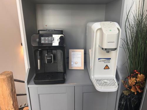 a coffeemaker and a coffee maker on a counter at Casa Larisa Antonia Apartment in Sinaia