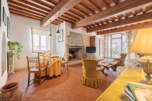 a living room with a table and a fireplace at Casamaggio in San Donato in Collina