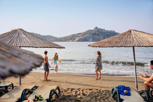 a group of people on a beach with umbrellas at TUI MAGIC LIFE Sarigerme in Sarigerme