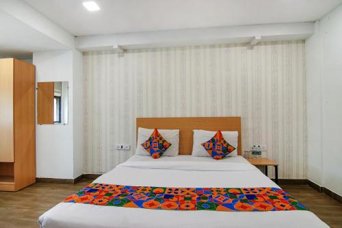 a bedroom with a large bed in a room at FabHotel Moro Rohini Sector 11 in New Delhi