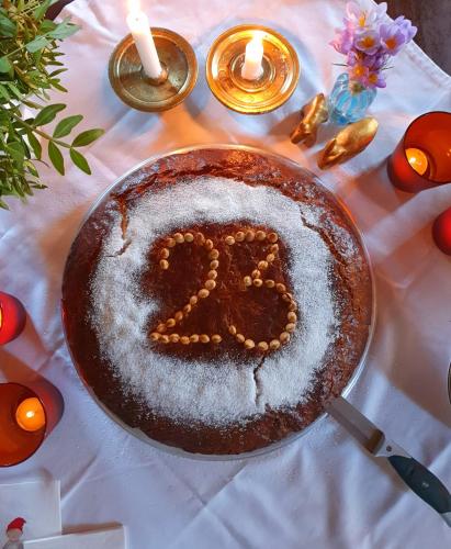 a cake with the number six on it on a table at Helicon Muses Friendly Mountain B&B Guesthouse in Evangelístria