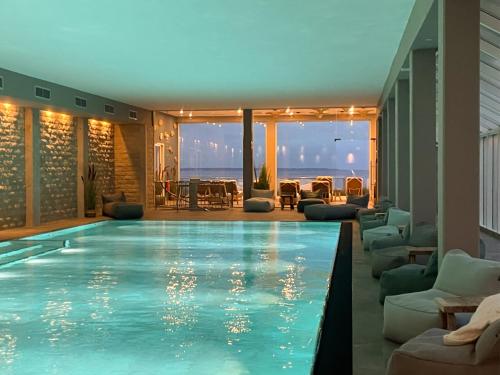 a swimming pool in a hotel with a view of the ocean at Grand Hotel Seeschlösschen Sea Retreat & SPA in Timmendorfer Strand