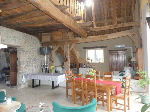 a dining room with a table and chairs in a building at Domaine Baraque in Pouillon