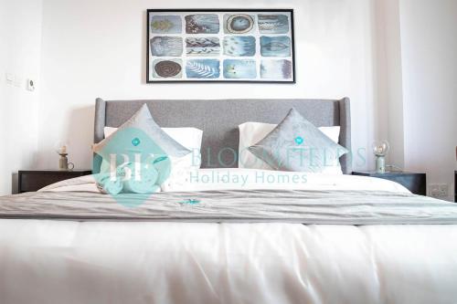 a bed with a happy halliday homes sign on it at Stylish Studio In Oasis in Abu Dhabi