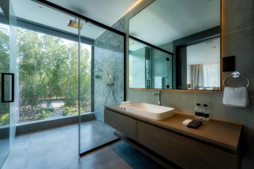 a bathroom with a sink and a mirror at Nurai Water Villa By Luxury Explorers Collection in Abu Dhabi