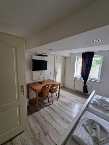 a room with a table and a room with a bed at GZ Hostel Bonn in Bonn